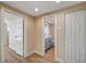 Hallway view with a modern bathroom featuring gray vanity and dual sinks at 7477 Ullom Dr, Las Vegas, NV 89139