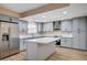 Modern kitchen with stainless steel appliances and a center island at 7477 Ullom Dr, Las Vegas, NV 89139