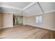 Bright living room featuring wood floors, neutral walls, and beamed ceilings at 7477 Ullom Dr, Las Vegas, NV 89139