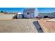 A backyard outbuilding, painted blue with a gray roof and a small window, great for storage or a workshop at 7477 Ullom Dr, Las Vegas, NV 89139