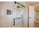 Luxurious shower with glass enclosure, rainfall showerhead, and elegant marble-like tiling at 7477 Ullom Dr, Las Vegas, NV 89139