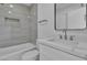 Bathroom with white vanity, marble countertop, and a shower-over-tub with gray tile surround at 7640 Sea Wind Dr, Las Vegas, NV 89128