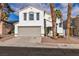 Charming two-story home featuring a neutral color scheme, a two-car garage, and a well maintained front yard at 7640 Sea Wind Dr, Las Vegas, NV 89128