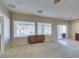 Bright living room with tiled floors, a sliding glass door, and a charming accent cabinet at 7649 Broadwing Dr, North Las Vegas, NV 89084