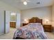 Main bedroom featuring a ceiling fan, wood furniture, and a view into the bathroom at 7649 Broadwing Dr, North Las Vegas, NV 89084