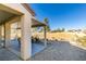 Covered patio features a dining set for outdoor entertaining, overlooking a grassy field at 7649 Broadwing Dr, North Las Vegas, NV 89084