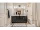 Bathroom featuring double sinks, a shower/tub, and a vanity mirror at 7788 Ebro Valley Ct, Las Vegas, NV 89113