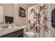 Cozy bathroom with a leaf-themed shower curtain and coordinated fixtures at 7788 Ebro Valley Ct, Las Vegas, NV 89113