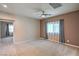 Bedroom with neutral paint, carpeting, and a large window with sheer curtains at 7788 Ebro Valley Ct, Las Vegas, NV 89113