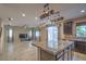 Open-concept kitchen and living area featuring an island with granite countertops and stainless steel appliances at 7788 Ebro Valley Ct, Las Vegas, NV 89113