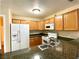 Kitchen with granite countertops, stainless steel sink and white appliances at 9325 W Desert Inn Rd # 250, Las Vegas, NV 89117