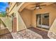 This covered back patio features an outdoor ceiling fan and access to the backyard at 9517 Alma Ridge Ave, Las Vegas, NV 89178
