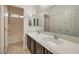 This bathroom features tile flooring, double sinks, and a shower-tub combination at 9517 Alma Ridge Ave, Las Vegas, NV 89178