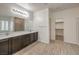 This spacious bathroom features wood-look flooring, double sinks, and a large mirror at 9517 Alma Ridge Ave, Las Vegas, NV 89178