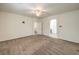 Bright bedroom features neutral carpeting, a ceiling fan, and an en suite bathroom at 9517 Alma Ridge Ave, Las Vegas, NV 89178