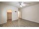 Spacious bedroom with wood-style flooring, ceiling fan, closet and doorways leading to other rooms at 9517 Alma Ridge Ave, Las Vegas, NV 89178