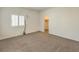 Bright bedroom features neutral carpeting, plantation shutters, and a walk-in closet at 9517 Alma Ridge Ave, Las Vegas, NV 89178