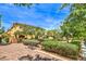 Well-manicured landscaping with a brick walking path and benches near homes at 9517 Alma Ridge Ave, Las Vegas, NV 89178