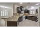 Kitchen with granite countertops, dark wood cabinets, and a breakfast bar at 9517 Alma Ridge Ave, Las Vegas, NV 89178