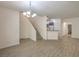 Bright and open-concept living space with modern light fixture and wood-look floors at 9517 Alma Ridge Ave, Las Vegas, NV 89178