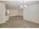 Open-concept living room features wood-look floors and a modern chandelier at 9517 Alma Ridge Ave, Las Vegas, NV 89178