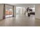 A spacious living room opens to the kitchen and patio with wood floors at 9517 Alma Ridge Ave, Las Vegas, NV 89178