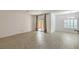 Bright living room with wood floors, access to the patio, and a view of the dining area at 9517 Alma Ridge Ave, Las Vegas, NV 89178