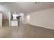 The living room is spacious and bright with wood floors and flows into the kitchen at 9517 Alma Ridge Ave, Las Vegas, NV 89178