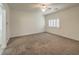 Main carpeted bedroom with shuttered windows providing ample natural light, with a ceiling fan at 9517 Alma Ridge Ave, Las Vegas, NV 89178