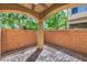 Private covered patio with brick pavers and a view of the surrounding landscape at 9517 Alma Ridge Ave, Las Vegas, NV 89178