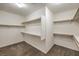 This walk-in closet has carpet flooring and multiple shelves and racks for storage at 9517 Alma Ridge Ave, Las Vegas, NV 89178