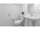 Cozy powder room featuring a pedestal sink, toilet, and modern fixtures for guests' convenience at 9714 Harper Edge St, Las Vegas, NV 89143