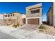 Beautiful modern home with a stone accent wall and a two-car garage with a stylish brick driveway at 9714 Harper Edge St, Las Vegas, NV 89143