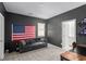 Cozy living room with a comfortable sofa, and American flag adding a personal touch at 9714 Harper Edge St, Las Vegas, NV 89143