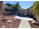 Landscaped backyard featuring stone walkway, mature trees, and covered patio at , Las Vegas, NV 89110