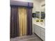Bathroom with tile flooring, white cabinets, and unique window coverings at , Las Vegas, NV 89110