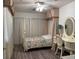 Bright bedroom with hardwood floors, beautiful vanity, floral bedspread, and a window with curtains at , Las Vegas, NV 89110