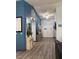 Hallway with hardwood floors, blue walls, decorative furniture, and an EXIT sign above the door at , Las Vegas, NV 89110