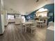 Bright living room with blue walls, hardwood floors, white dining table, and kitchen in the background at , Las Vegas, NV 89110