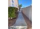 Long side yard features a walkway, small bush, and view of the home at , Las Vegas, NV 89110