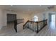 A staircase with elegant black wrought iron railing and light wood-look flooring at 3120 Stern Dr, Las Vegas, NV 89117