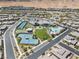 A high angle showcasing the neighborhood pool, tennis courts, clubhouse, and surrounding community at 10057 Regency Canyon Way, Las Vegas, NV 89148