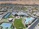 A high angle showcasing the neighborhood pool, tennis courts, clubhouse, and surrounding community at 10057 Regency Canyon Way, Las Vegas, NV 89148
