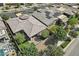 This aerial view highlights a modern single-story home with a landscaped backyard and community at 10057 Regency Canyon Way, Las Vegas, NV 89148