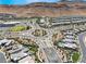 Expansive aerial shot of the beautiful community with desert landscaping and mountain views at 10057 Regency Canyon Way, Las Vegas, NV 89148