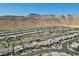 Wide aerial view showcasing the community, nearby mountains, and expansive neighborhood layout at 10057 Regency Canyon Way, Las Vegas, NV 89148