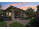 Covered back patio with brick pavers, artificial grass, desert landscaping, and privacy at 10057 Regency Canyon Way, Las Vegas, NV 89148