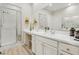 Bright bathroom features a glass-enclosed shower and a vanity with white countertop at 10057 Regency Canyon Way, Las Vegas, NV 89148