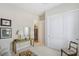 Bedroom with a mirrored closet, vintage decor and table with a lamp at 10057 Regency Canyon Way, Las Vegas, NV 89148