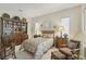 Comfortable bedroom featuring a large bed, antique furnishings, and natural light at 10057 Regency Canyon Way, Las Vegas, NV 89148